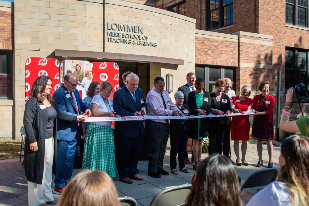 The Nibbe family and university community cut the ribbon at the Nibbe School of Teaching & Learning.